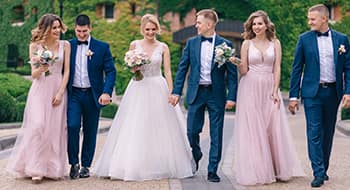 a bride and groom surrounded by their bridesmaids and groomsmen